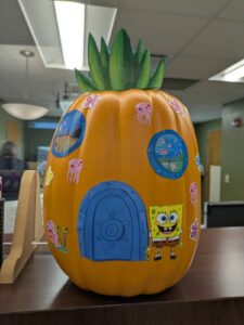 orange pumpkin decorated like SpongeBob Squarepants' house.